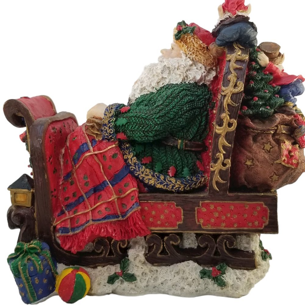 Santa in a Red Sleight Bed Resin Holiday Décor with Elves, Presents, And Toys - Picture 4 of 15